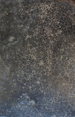 Cracked Dark Surface. Close-up of a dark cracked surface with fine web-like lines, evoking an aged or weathered appearance.