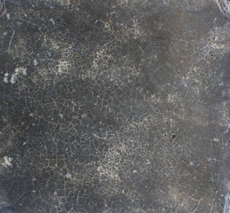 Cracked Dark Surface. Close-up of a dark cracked surface with fine web-like lines, evoking an aged or weathered appearance.