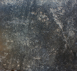 Cracked Dark Surface. Close-up of a dark cracked surface with fine web-like lines, evoking an aged or weathered appearance.