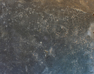 Cracked Dark Surface. Close-up of a dark cracked surface with fine web-like lines, evoking an aged or weathered appearance.
