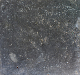 Cracked Dark Surface. Close-up of a dark cracked surface with fine web-like lines, evoking an aged or weathered appearance.