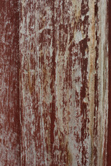 Cracked Red Painted Wood. Close-up of red painted wood with large cracks and weathered paint, showing deep texture and age.