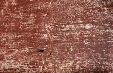 Cracked Red Painted Wood. Close-up of red painted wood with large cracks and weathered paint, showing deep texture and age.