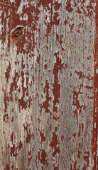 Cracked Red Painted Wood. Close-up of red painted wood with large cracks and weathered paint, showing deep texture and age.