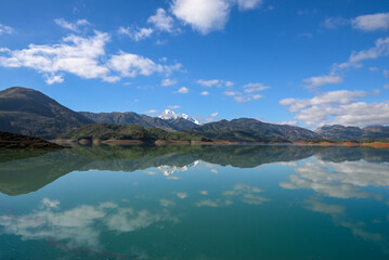 Obraz premium African lake, sunset in an African lake full of green grass and blue water with clouds, African landscape and lake and river water in Jijel, Algeria, nature and environment of Africa, Bodies of Water.