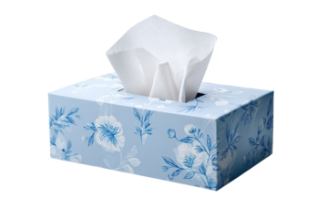A light-blue tissue box, decorated with a floral pattern of white flowers and delicate blue outlines, holds a stack of white tissues