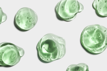 Cosmetic green gel or lotion or aloe vera or centella asiatica cica transparent gel drops texture background
