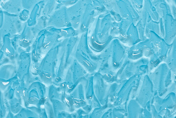 Gel texture on blue background. Cosmetic banner with transparent gel with bubbles. Skincare serum. Beauty concept