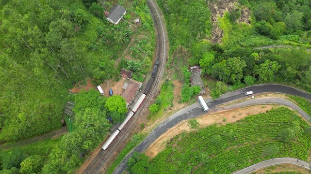Aerial drone footage of Sri Lankan Sri Lanka train traveling from Kandy to Ella through scenic hills and lush countryside landscapes