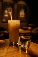 Iced Latte and Water Glass on Wooden Table in Cozy Cafe