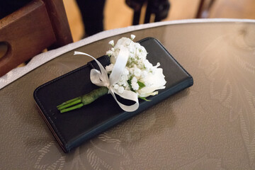 Corsage resting on an elegant table, capturing the essence of celebration and anticipation before a...