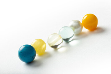 Beads of various colors on a white background.