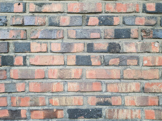 brick wall made of red and distressed black brick. space for text