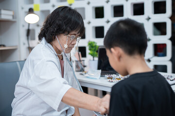 Fototapeta premium A pediatrician uses a stethoscope during a health examination at the clinic.