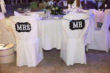 Elegant wedding seating decor with Mr. and Mrs. signs at a charming reception venue