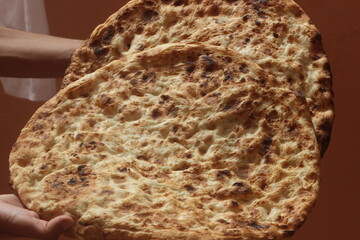 Hands holding tafarnout bread