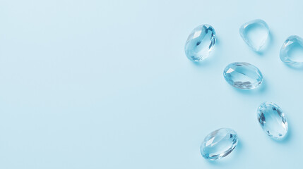 polished aquamarine gemstones on pastel blue background, elegant flat lay, minimal composition