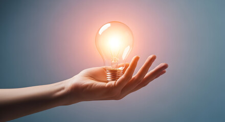 Hand Holding Glowing Light Bulb Idea Concept