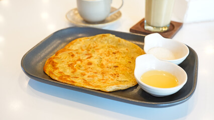 Baked roti prata canai or paratha flat bread

