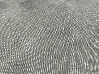 Horizontal close-up of grey t-shirt fabric with detailed woven texture. Soft, natural gray fibers, neutral background pattern. Wallpaper design for textile and fashion close up