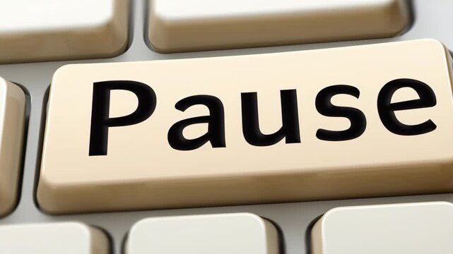 A close-up of a keyboard with a large beige key labeled 'Pause' in black letters.