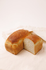omemade grey brick bread with golden crust, traditional rectangular loaf.