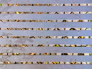 A weather-resistant, textured background for a small cafe table in a public park, made of iron. Durable, comfortable, and ideal for outdoor public spaces, parks, sidewalks, or recreational areas.