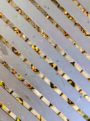 A weather-resistant, textured background for a small cafe table in a public park, made of iron. Durable, comfortable, and ideal for outdoor public spaces, parks, sidewalks, or recreational areas.