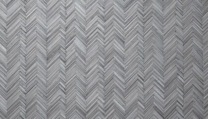 Close up of a gray herringbone pattern wood floor creating a textured zigzag design surface and background