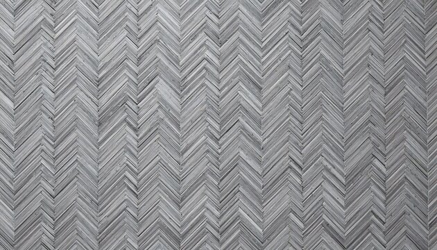 Close up of a gray herringbone pattern wood floor creating a textured zigzag design surface and background