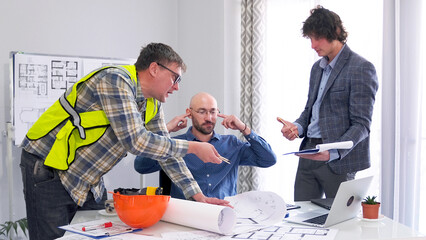 The engineer and the designer are arguing in the office. The chief architect puts his fingers in his ears so as not to listen to the bad ideas of his colleagues