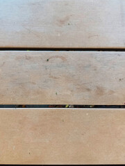 A weather-resistant, textured background for a small cafe table in a public park. Made of wood with a metal frame. Durable, comfortable, and ideal for outdoor public spaces, or recreational areas.
