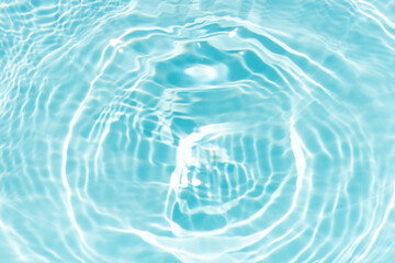 Blue water with ripples on the surface. Defocus blurred transparent blue colored clear calm water surface texture with splashes and bubbles. Water waves with shining pattern texture background.