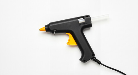 Close-up of black glue gun on white background, essential crafting tool for DIY projects
