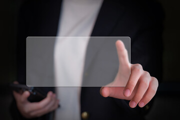 Close-up of a businesswoman's hand holding a glass display screen for advertising text.
