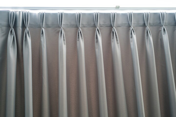 Grey curtains with header rail on a window in a modern home