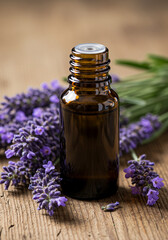 Aromatic essential oil bottle surrounded by fresh purple lavender blossoms.