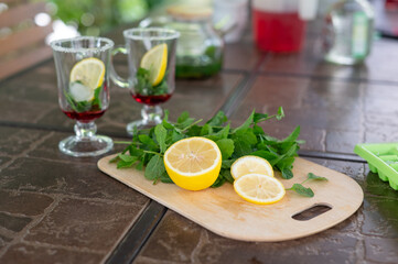 Ingredients for making a mojito at home. Lemon, mint, two glasses with syrup. summer. a refreshing drink
