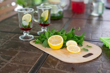 Ingredients for making a mojito at home. Lemon, mint, two glasses with syrup. summer. a refreshing drink