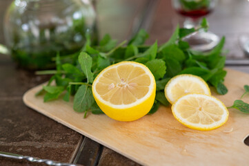 Ingredients for making a mojito at home. Lemon, mint, two glasses with syrup. summer. a refreshing drink