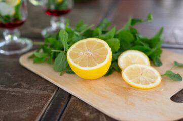 Ingredients for making a mojito at home. Lemon, mint, two glasses with syrup. summer. a refreshing drink