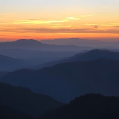 Fototapeta premium Sunrise over a misty mountain range, showcasing layered peaks and a vibrant sky.