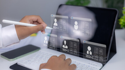 Recruitment technology, Concept of online hiring, human resources, and digital employment process. Businessman reviewing digital resumes on virtual screen using stylus and tablet.