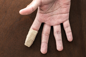 Forefinger finger immobilizer after hand injury. Medical splint on broken finger. Medical...