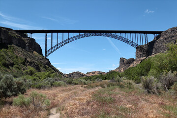 A gorgeous bridge between the rocks. Below it is a valley of thorny bushes