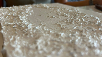 Close-up view of a painting on a canvas in an art studio