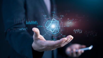 Businessman’s hand holding futuristic hologram interface with financial charts, performance metrics, and data analytics for strategic planning, digital transformation, innovation in business analysis