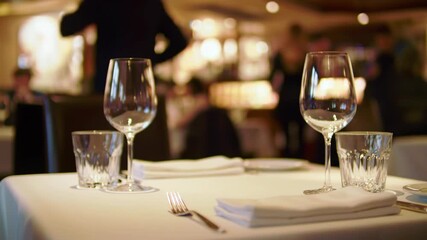 Elegant restaurant table setting with wine glasses awaiting guests for a fine dining experience at a luxury culinary establishment
