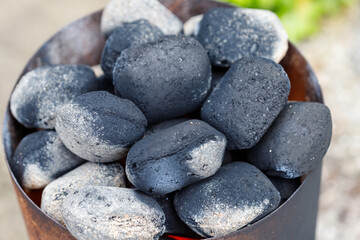 Charcoal Briquettes in a Metal Container