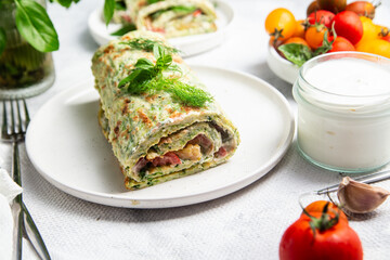 Appetizing zucchini roll with tomatoes and garlic on a light background